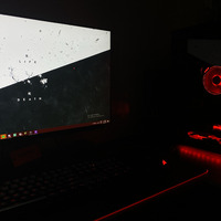 A picture taken of a PC in the dark, which is covered in red LED lights. 