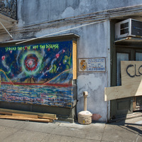 A mural next to a closed building.