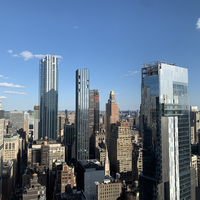 A photo taken within a city shows skyscrapers and other buildings around.
