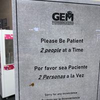 Sign for "GEM PAWNBROKERS" with text, "Please Be Patient: 2 people at a Time: Por favor sea Paciente: 2 Personas a la Vez: Sorry for any Inconvience: Perdona por la Inconveniencia"