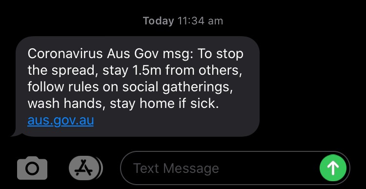 A text from the Australia Government stating, "Coronavirus Aus Gov msg: To stop the spread, stay 1.5m away from others, follow rules on social gatherings, wash hands, stay home when sick. aus.gov.au."