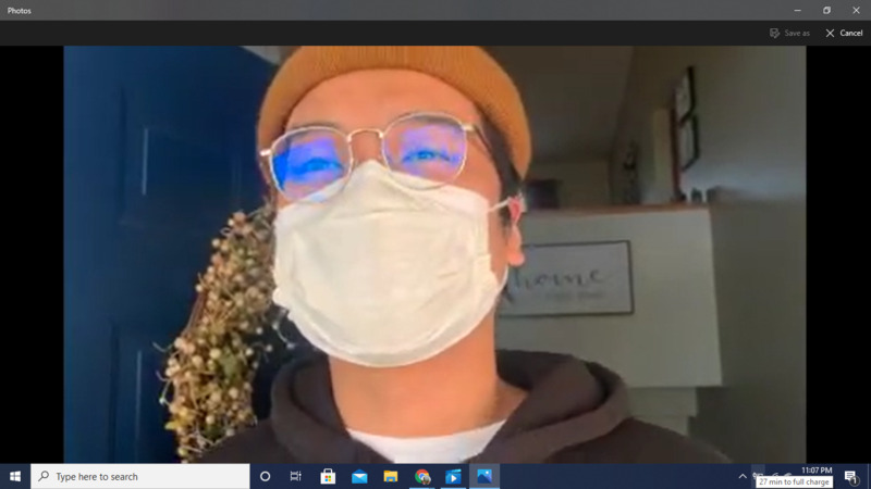 Screenshot of person in mask on Zoom.