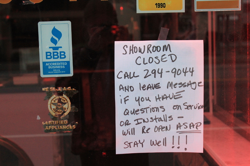 A handwritten sign saying:
"Showroom closed. Call 294-9044 and leave message if you have questions on service or install- will reopen ASAP. Stay well!"