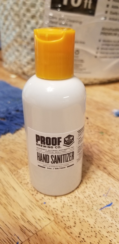 A orange and white hand sanitizer bottle. 