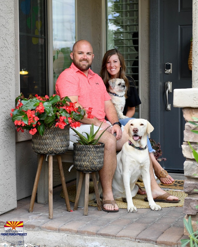 A couple posing with their dogs. 
