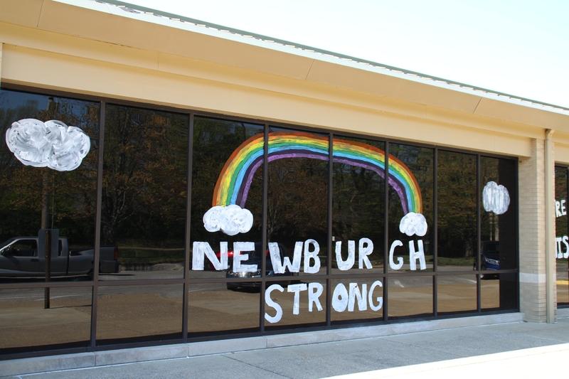 Window Writing reading "Newburgh Strong" along with a drawing of a rainbow. 