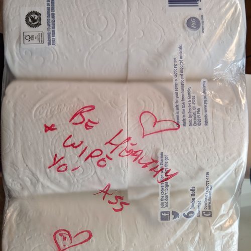 Toilet paper with a written message on the packaging. 