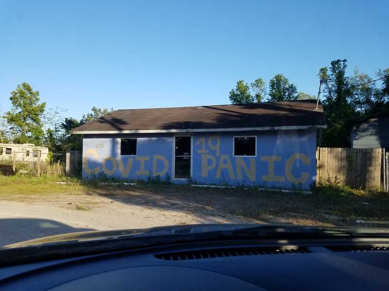 An empty house with a message on the front. 