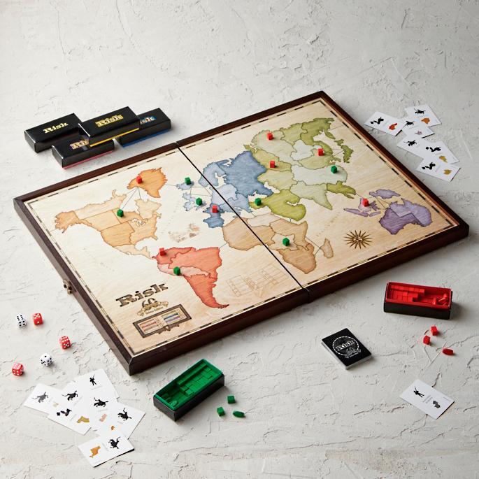 A wooden board game, Risk, with game accessories.