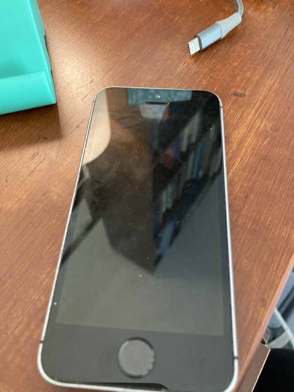 A phone with a blank screen on a table. 