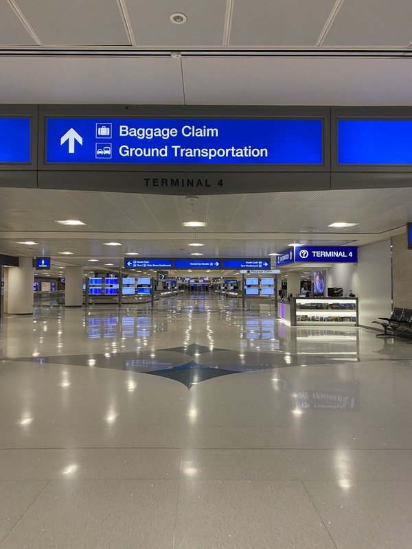 An airport terminal (terminal 4) that is pointing to where baggage claim and arrivals are. 
