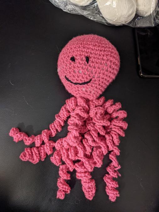 Crocheted pink octopus.