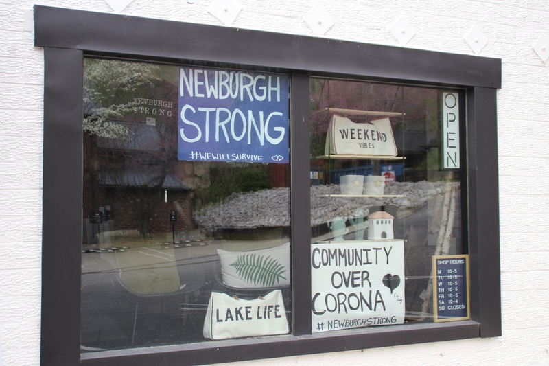 A sign in a business reading "Newburgh Strong #wewillsurvive".