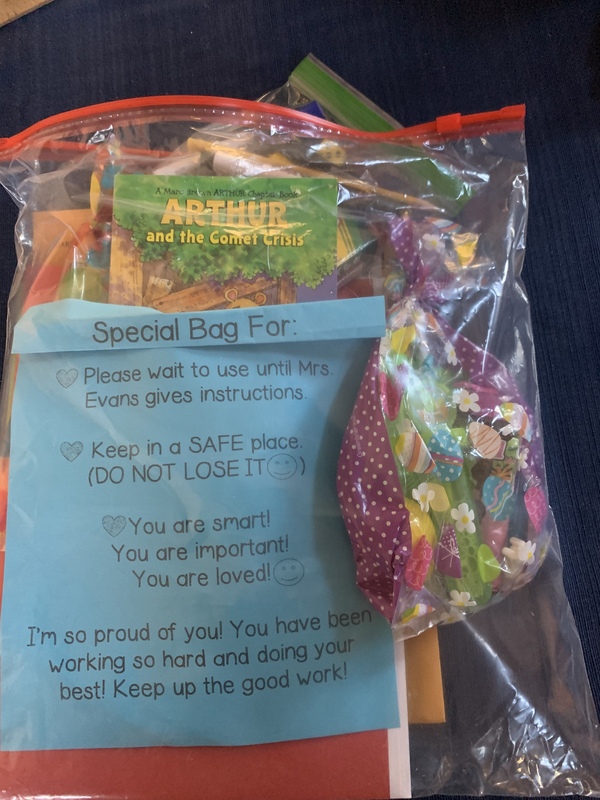 This is a picture of a gift bag that was made for a student by their teacher. A note inside it reads: "Special bag for: (blank). Please wait to use until Mrs. Evans gives instructions. Keep in a SAFE place (DO NOT LOSE IT). You are smart! You are important! You are loved! I am so proud of you! You have been working so hard and doing your best! Keep up the good work!" Several pieces of paper and a small book appear to be in the bag. 