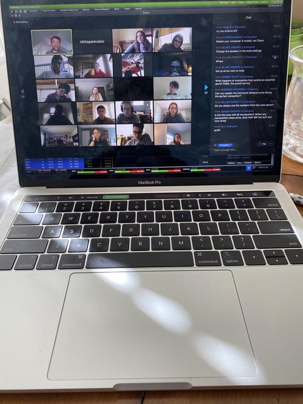 A Macbook Pro that has a Zoom meeting on the screen. 