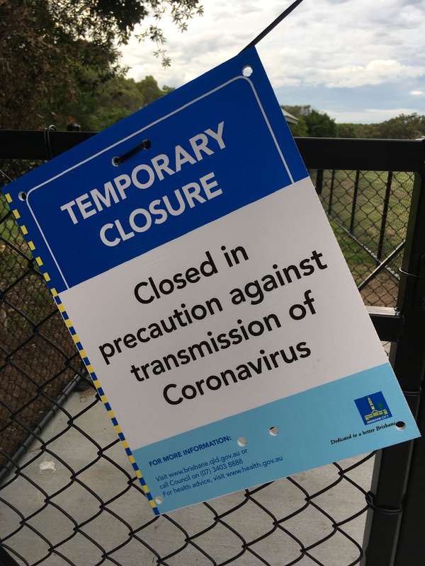 This is a picture of a sign at a park which reads: "Temporary Closure: Closed in precaution against transmission of Coronavirus."