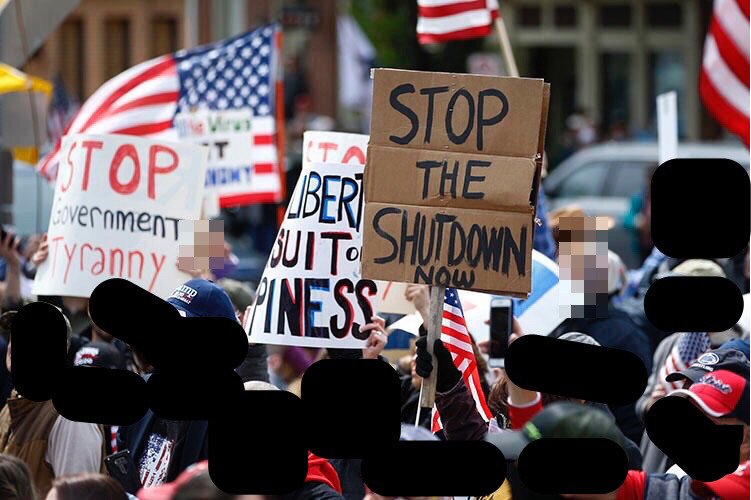 A picture of a crowd protesting the shutdown of businesses during the pandemic. 