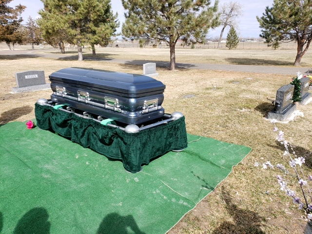 This is a picture taken of a coffin laid to rest at a funeral. 