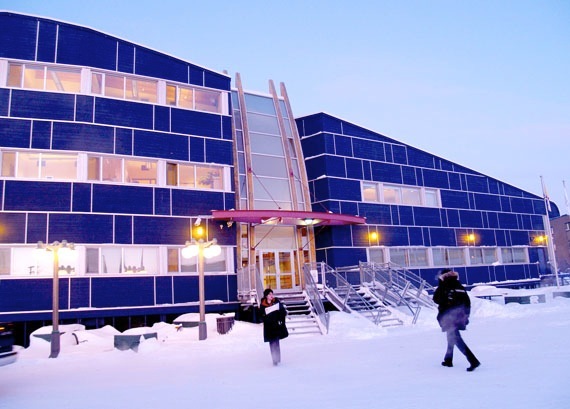 This is a picture of the legislature building of the town of Nunavut in Canada. The building is covered in snow. 