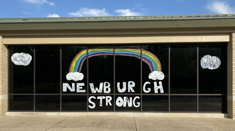 Window writing reading "Newburgh Strong" as well as a rainbow.