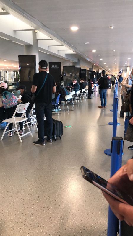 People waiting in line to be Covid tested at an airport. 