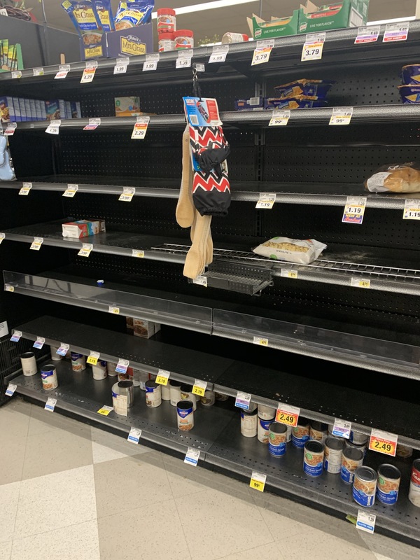 Depleted shelves in a grocery store. 