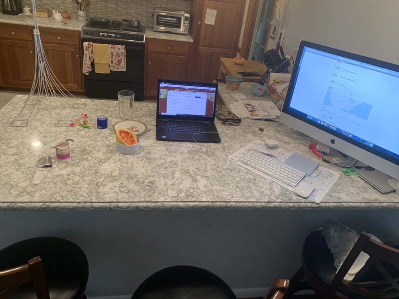 Image of someone's set up in their kitchen while they work from home.