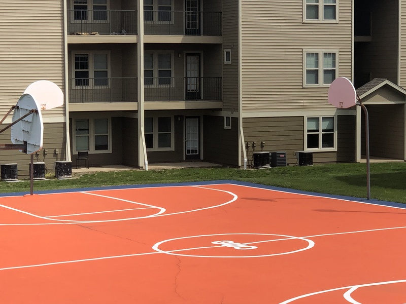 An empty basketball court at an apartment complex. 