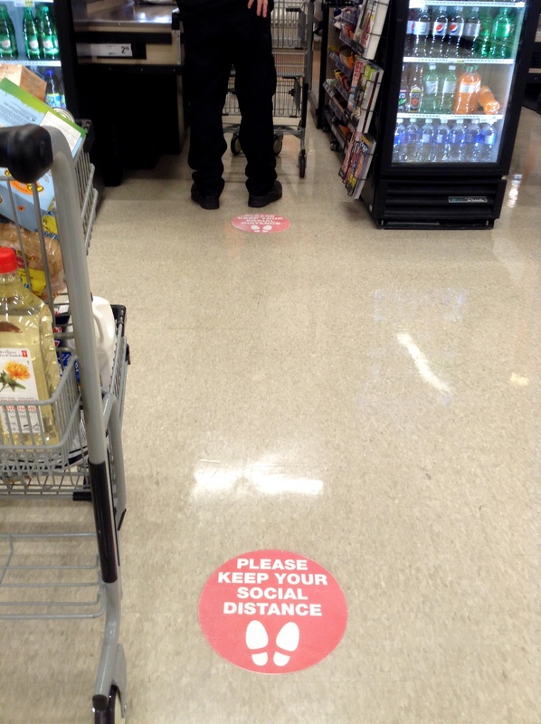 Person standing in line at a grocery store. 