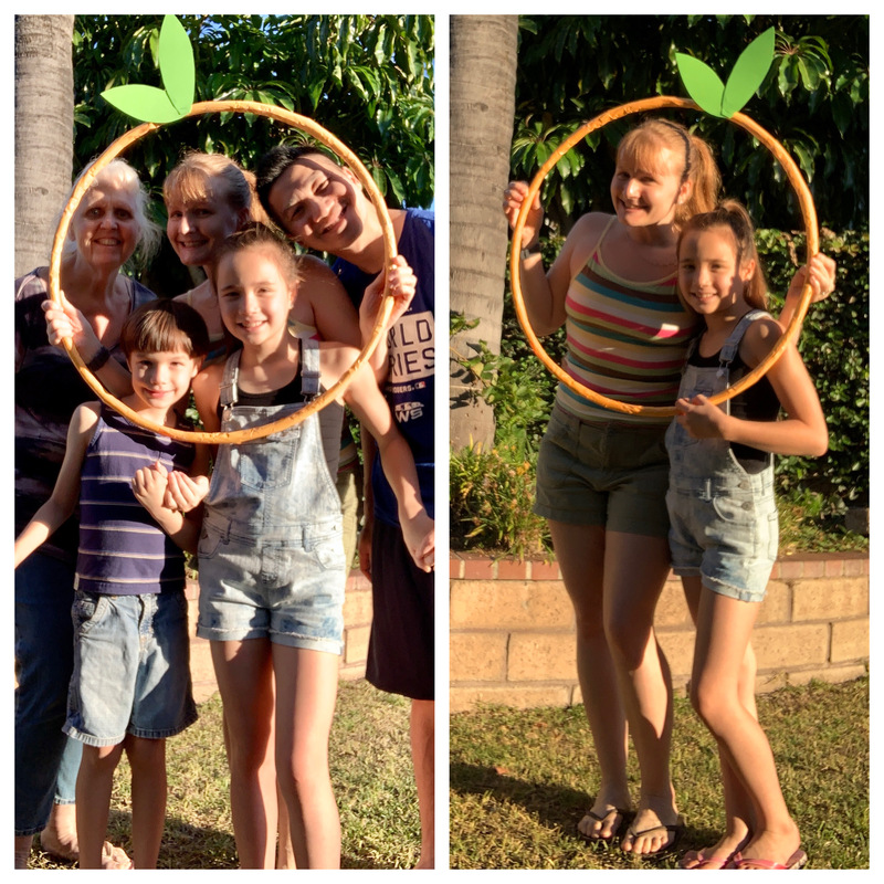 A family posing with an outline of an orange. 