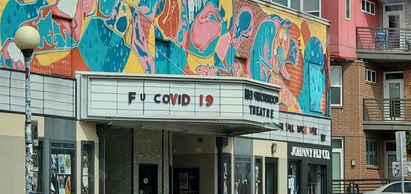 "NEIGBORHOOD THEATRE" a.k.a NoDa theatre marquee with the text "F U COVID 19"