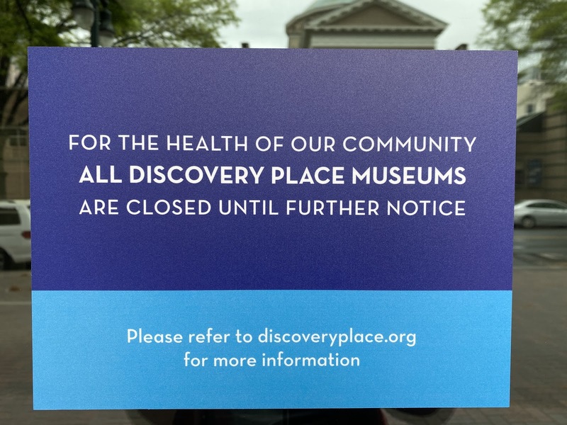 Closure sign at Discovery Place Museum that says "For the health of our community all Discovery Place Museums are closed until further notice."