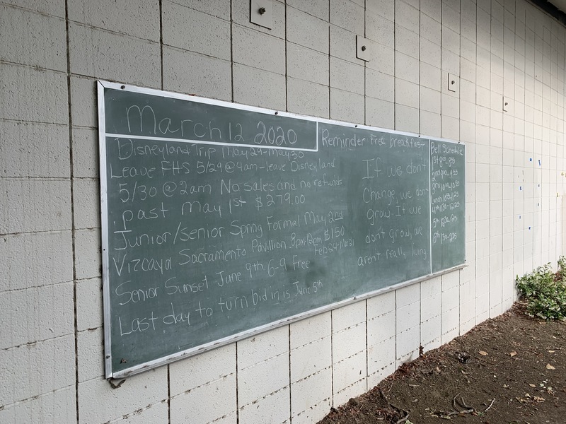 Image of a large chalkboard outside of a school with events written on it from March 12, 2020.