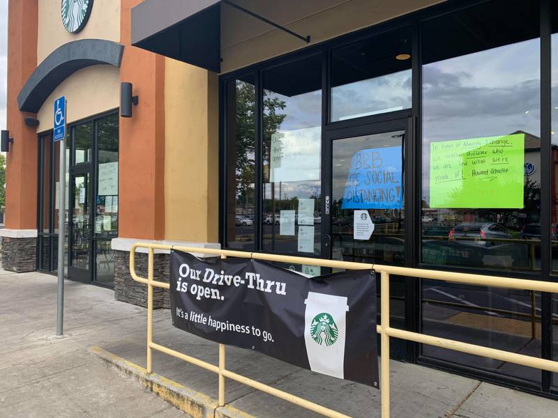 a sign stating that the Starbucks drive threw is open but not inside