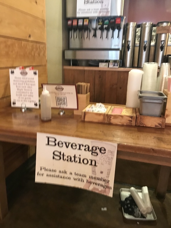 This is a picture taken of a beverage station at a restaurant that has been changed to be operated only by staff, to minimize customer contact and the potential spread of COVID-19. 