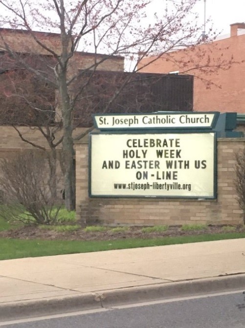 A sign in front of a church.