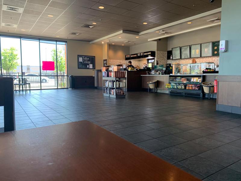 an empty Starbucks except one employee