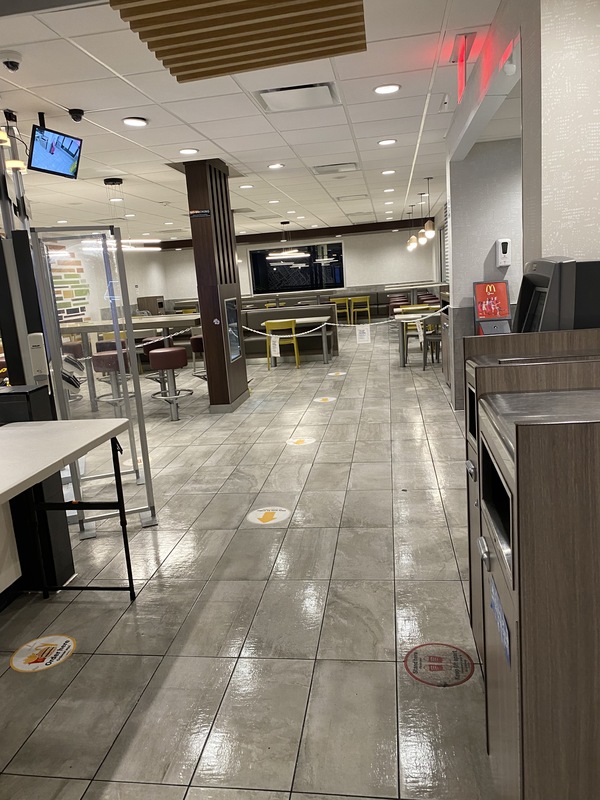 This is a picture taken of a very empty McDonald's restaurant. 