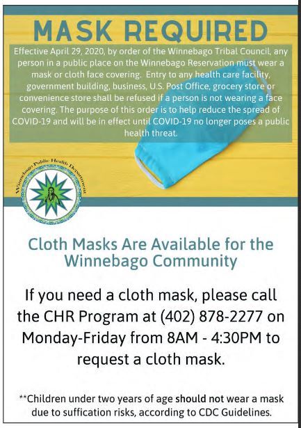A photo of a poster informing people that any person in a public space on the Winnebago reservation is mandated to wear a mask.