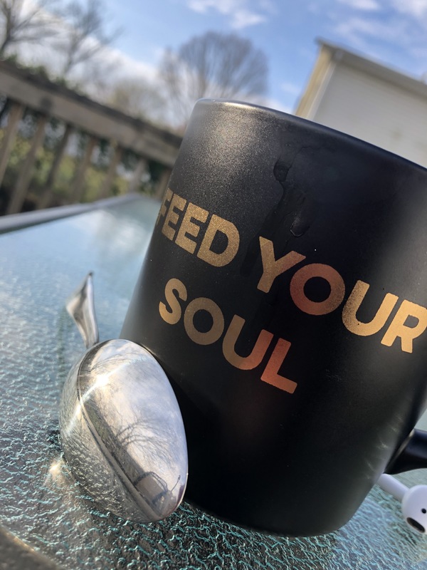 A coffee mug that has "Feed You Soul" on it. 