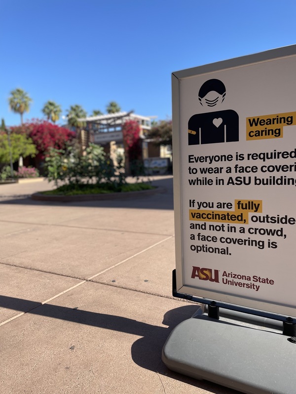 This is a picture taken of a sign that has been put up on ASU campus reading: "Everyone is required to wear a face covering while in ASU buildings. If you are fully vaccinated, outside, and not in a crowd, a face covering is optional." 