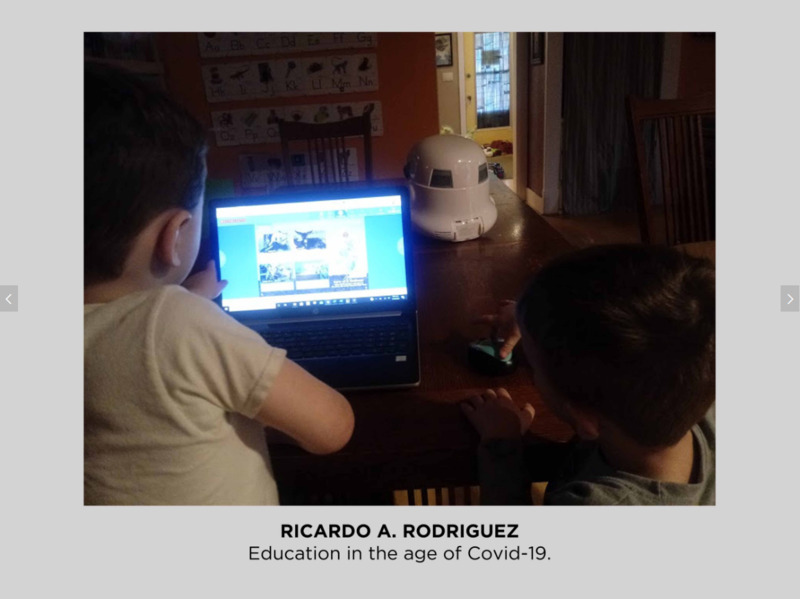 Photo of two children in front of a computer. 