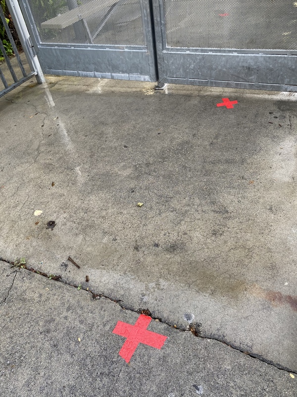 Two red X's on the ground six feet apart. 