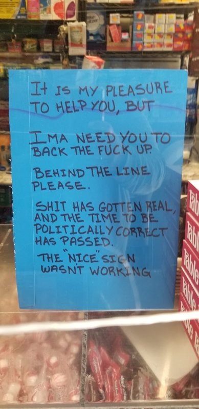 A store window with a sign that informs patrons that they need to keep their distance while inside. 