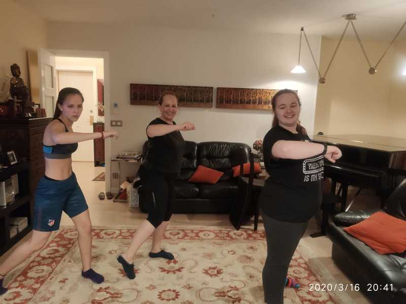Three people exercizing in a room. 