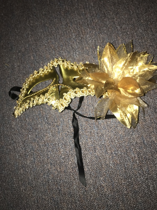 A broken golden party mask. 