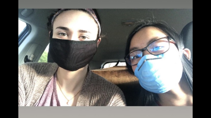 Two people with masks posing for a picture.