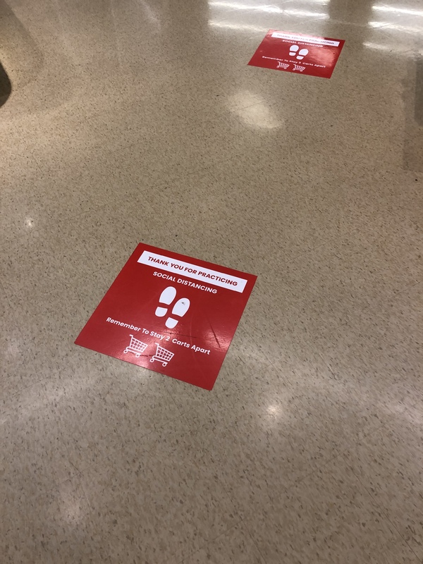 Social distancing stickers on the floor. 