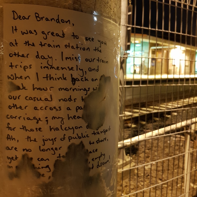 Photo of a message left at a train station by a passenger to their friend, expressing how much they miss spending their regular commute together. 