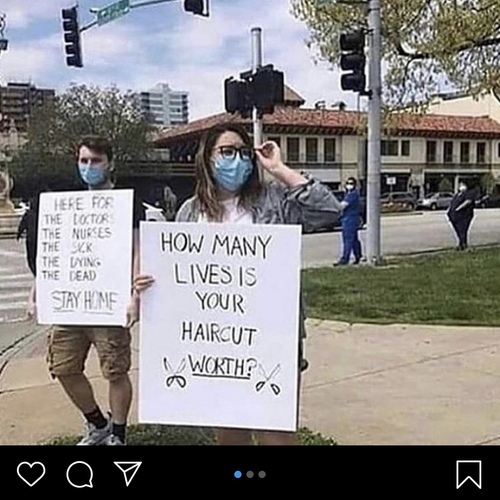 A woman holding a sign that reads "How many lives is your haircut worth?"